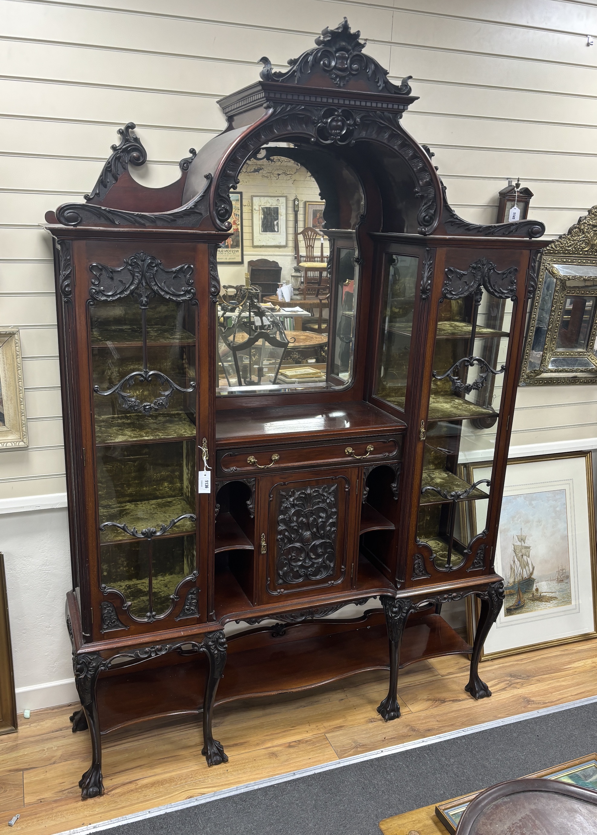 A late Victorian glazed carved mahogany side cabinet, width 157cm, depth 38cm, height 228cm